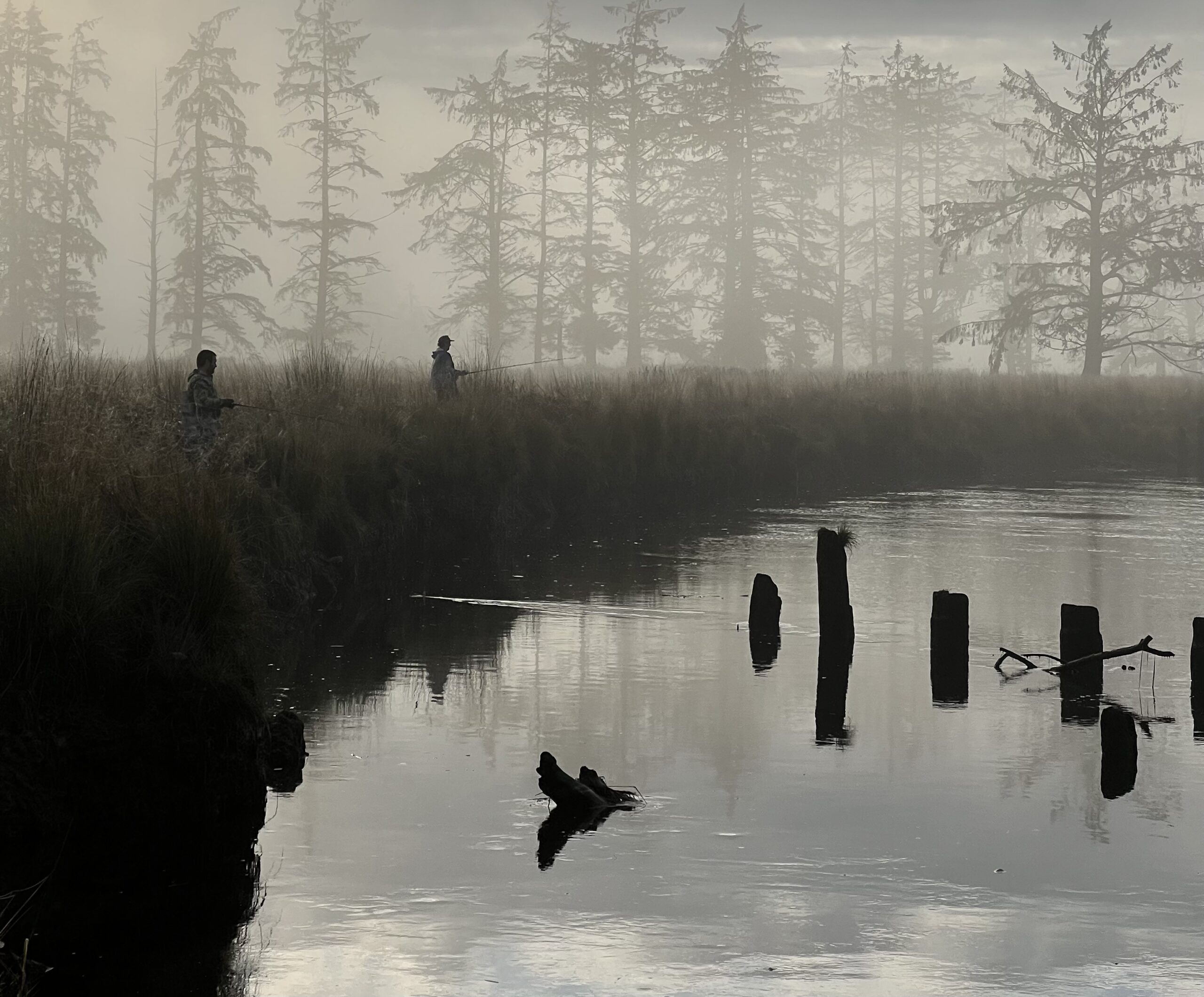 Anglers fishing for Chinook salmon on a foggy Oregon coast river