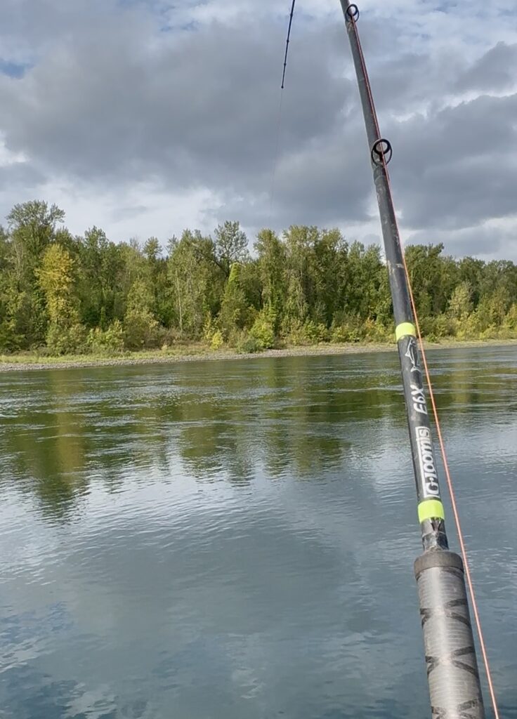 Salmon fishing rod and line setup over a river in the Pacific Northwest